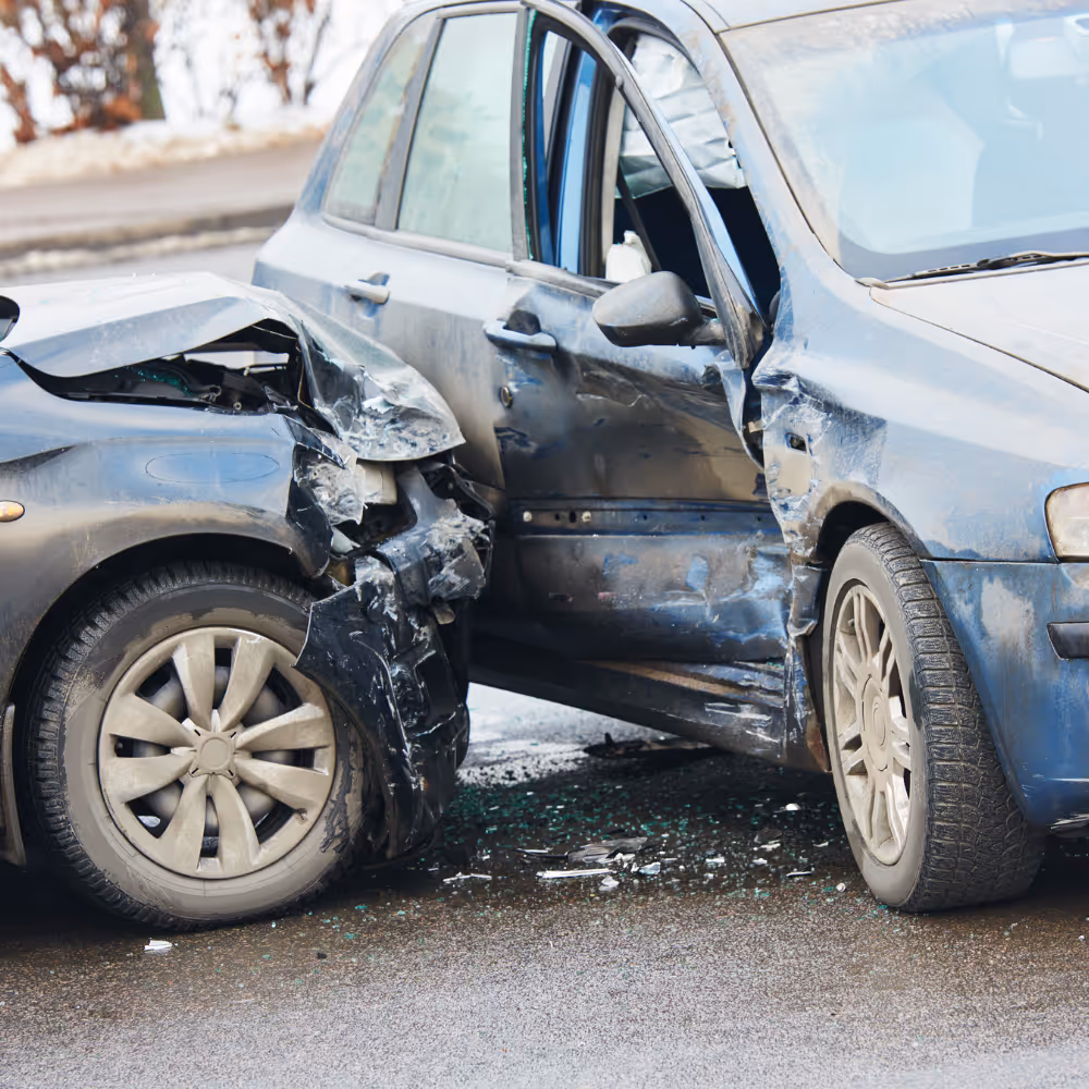 Two cars collided with major damage to the front of one and the driver's side of the other.